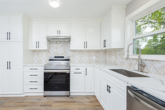 kitchen featuring light stone countertops, sink, light hardwood / wood-style floors, stainless steel appliances, and white cabinets