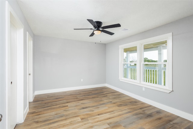 empty room featuring hardwood / wood-style floors, a textured ceiling, and ceiling fan