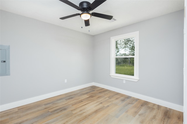 empty room with light hardwood / wood-style floors, electric panel, and ceiling fan