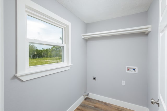 laundry room featuring dark hardwood / wood-style floors, a textured ceiling, washer hookup, and electric dryer hookup