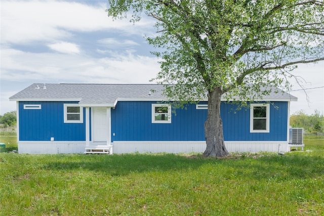 view of front of house featuring a front yard and central AC unit