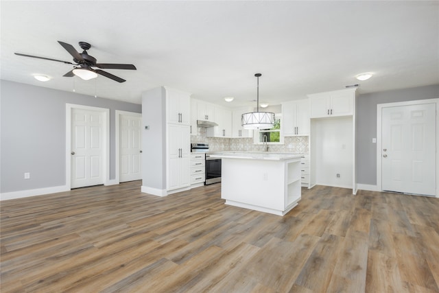 kitchen featuring white cabinetry, stainless steel range with electric cooktop, pendant lighting, and a kitchen island