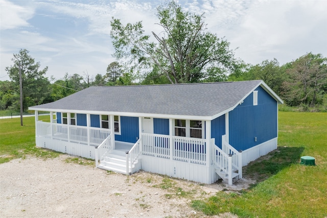 view of front of home featuring covered porch and a front yard