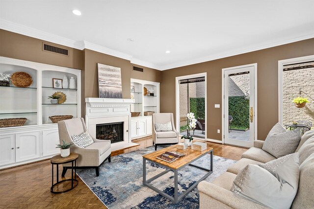 living room with light parquet floors, crown molding, and built in features