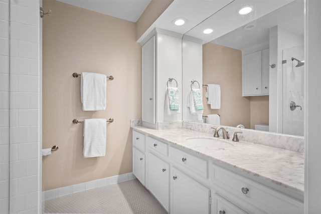 bathroom featuring vanity, tile patterned floors, toilet, and walk in shower