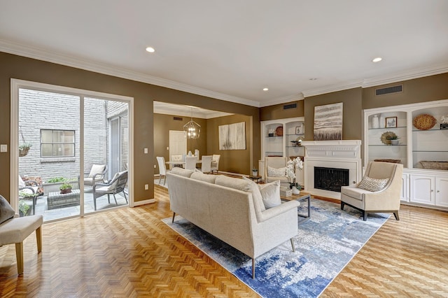 living room featuring a notable chandelier, crown molding, and light parquet flooring