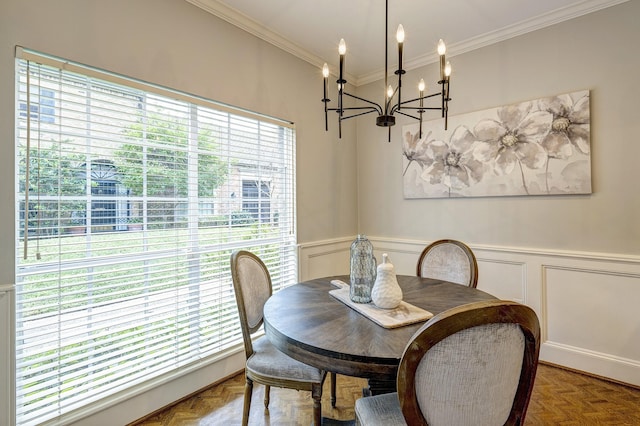 dining area featuring crown molding, parquet floors, and a chandelier