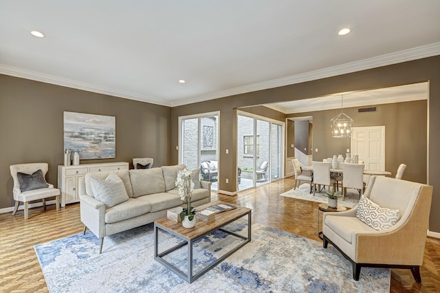 living room with a notable chandelier, crown molding, and light parquet floors