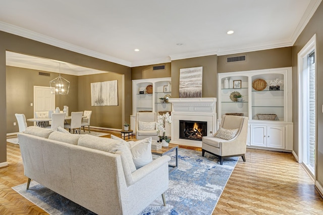 living room featuring light parquet floors, ornamental molding, and an inviting chandelier