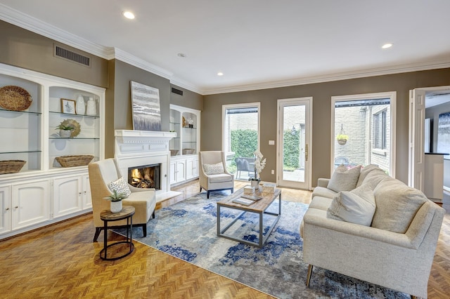 living room featuring light parquet flooring, crown molding, and built in shelves