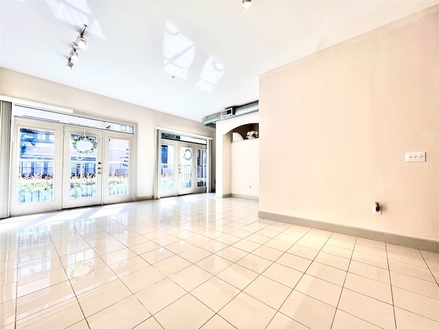 unfurnished room with french doors and light tile patterned floors