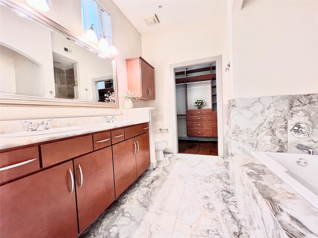 full bathroom featuring vanity, shower with separate bathtub, and toilet