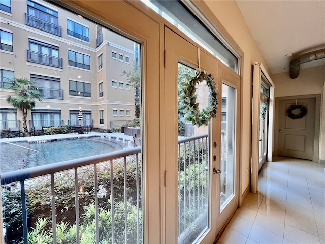 doorway featuring french doors, a healthy amount of sunlight, and light tile patterned floors