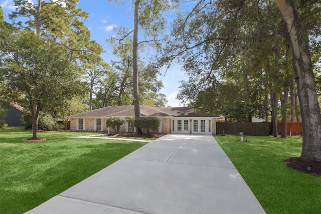 ranch-style home with a front yard and french doors