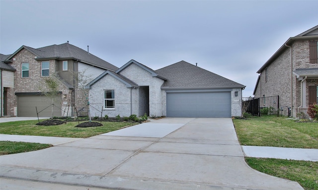 view of front of house featuring a garage and a front lawn