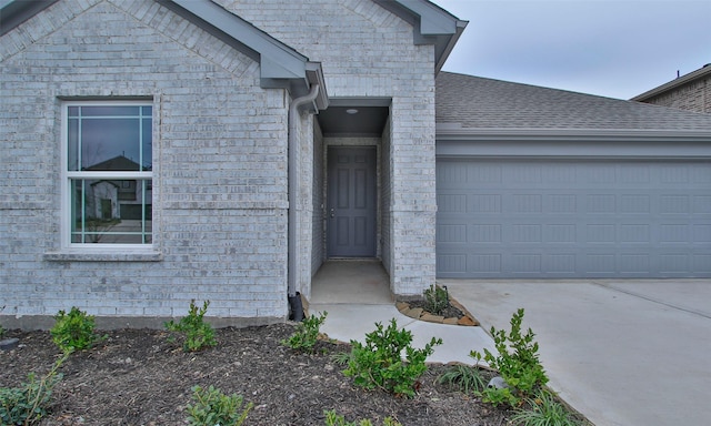 view of exterior entry with a garage