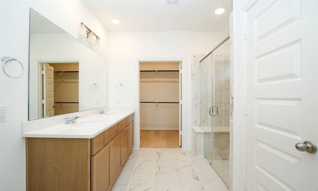 bathroom with vanity and a shower with shower door