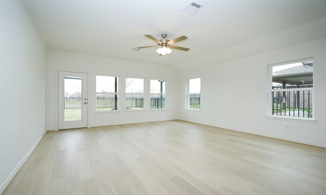 spare room featuring ceiling fan, light hardwood / wood-style floors, and plenty of natural light