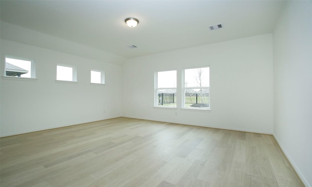 spare room with light hardwood / wood-style flooring