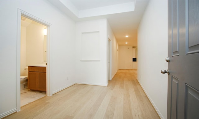 corridor with light hardwood / wood-style floors