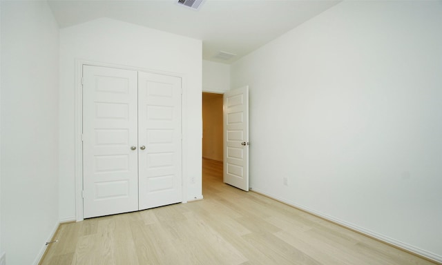 unfurnished bedroom with light hardwood / wood-style flooring and a closet