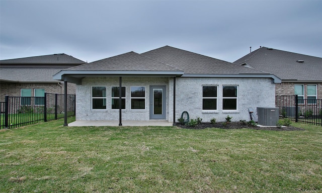 rear view of property with a patio area, a yard, and cooling unit