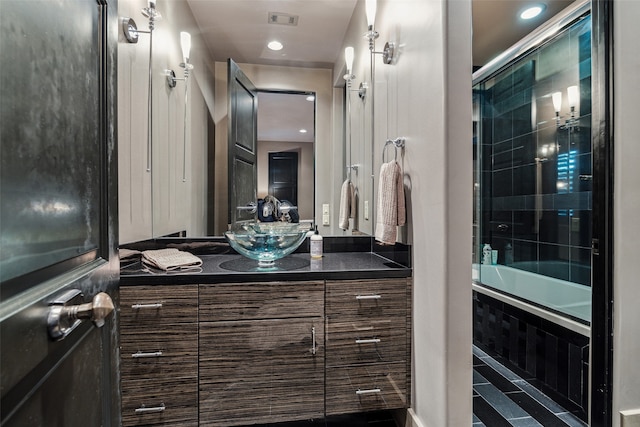 bathroom featuring bath / shower combo with glass door and vanity