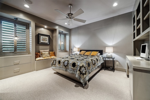 bedroom featuring ceiling fan and light carpet