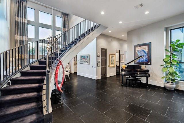 staircase featuring a high ceiling