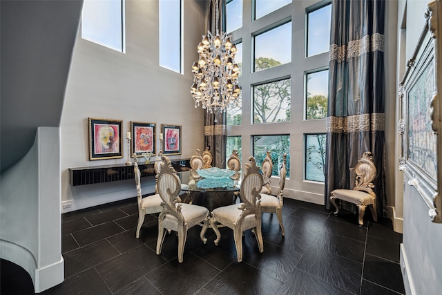 dining room with a high ceiling and a chandelier