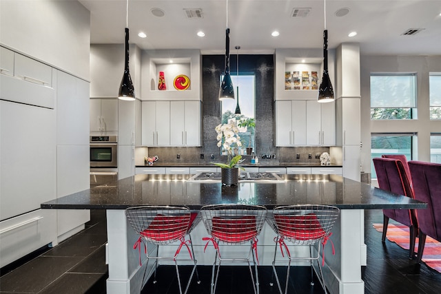 kitchen with a breakfast bar, stainless steel appliances, and a large island