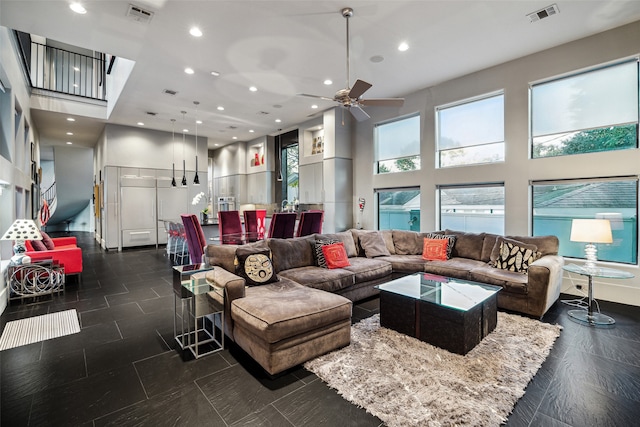 interior space featuring ceiling fan and a high ceiling