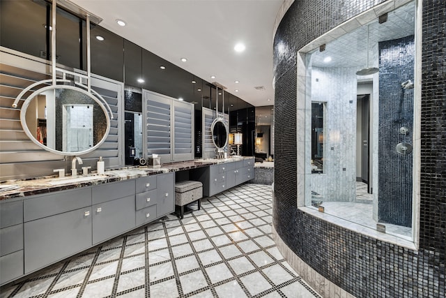 bathroom featuring a tile shower and vanity