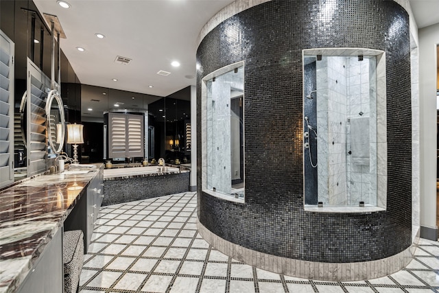 bathroom featuring vanity and separate shower and tub