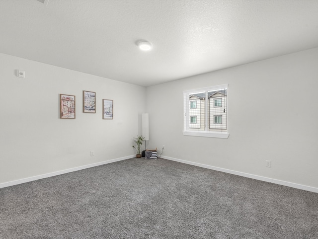 spare room featuring a textured ceiling and carpet flooring