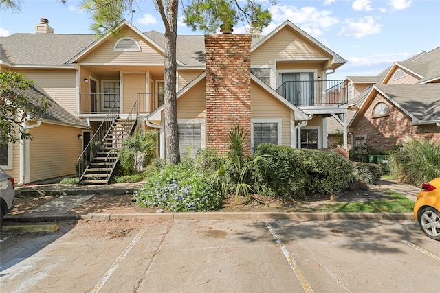 view of front of house featuring a balcony