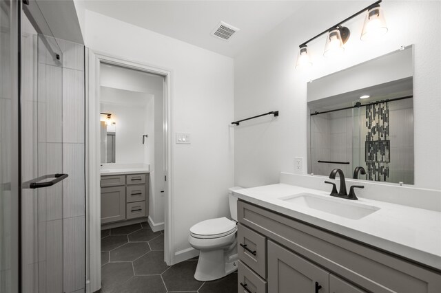 bathroom featuring a shower with shower curtain, tile patterned floors, vanity, and toilet