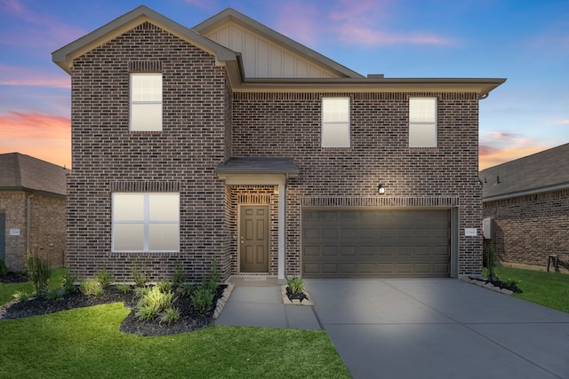 front facade with a lawn and a garage