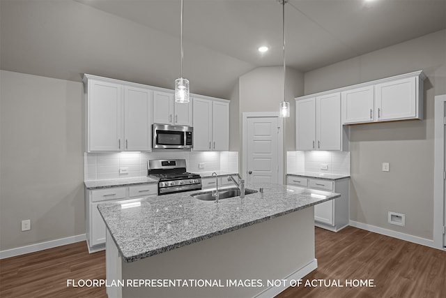 kitchen with lofted ceiling, white cabinetry, and stainless steel appliances