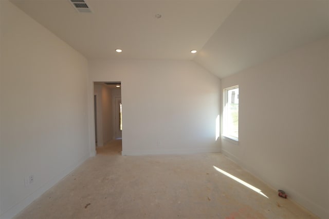 empty room featuring vaulted ceiling