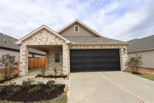 view of front of home featuring fence, driveway, a garage, board and batten siding, and brick siding