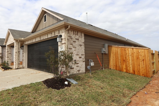 view of property exterior with stone siding, fence, board and batten siding, a garage, and brick siding