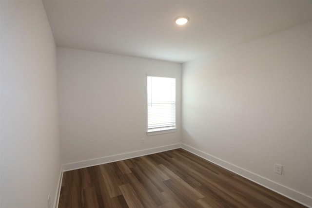 unfurnished room featuring dark wood finished floors and baseboards