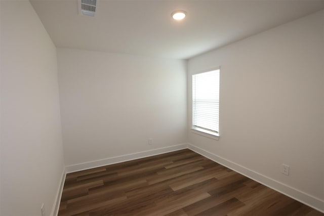 empty room featuring recessed lighting, visible vents, baseboards, and dark wood-style floors