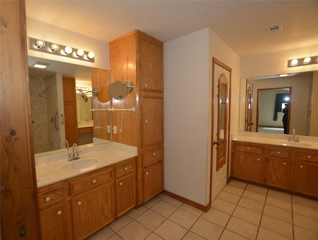 bathroom featuring walk in shower, vanity, and tile patterned floors