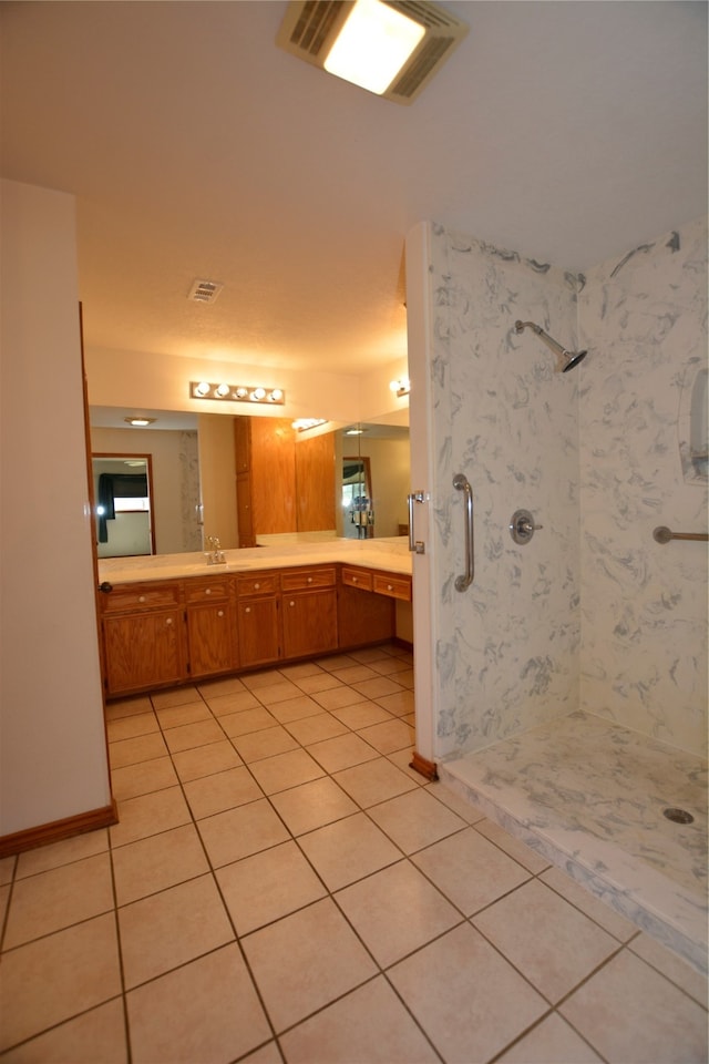 bathroom featuring vanity, tile patterned floors, and a shower with shower door