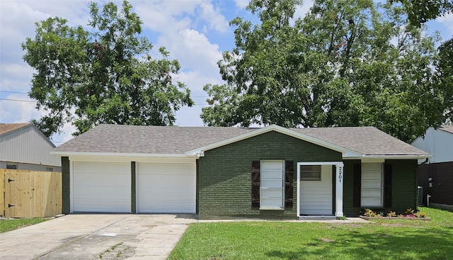 single story home with a garage and a front lawn