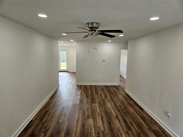 empty room featuring dark hardwood / wood-style floors and ceiling fan