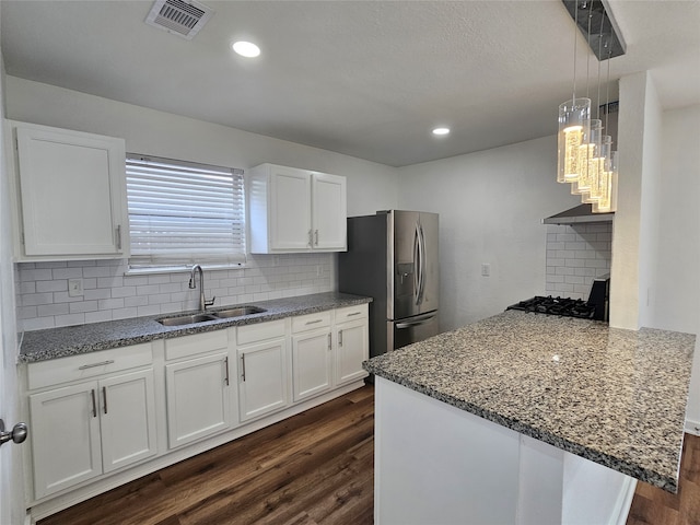 kitchen with dark hardwood / wood-style flooring, sink, stainless steel fridge with ice dispenser, and white cabinetry