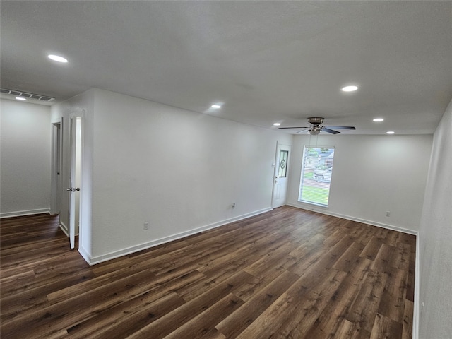 spare room with dark hardwood / wood-style floors and ceiling fan